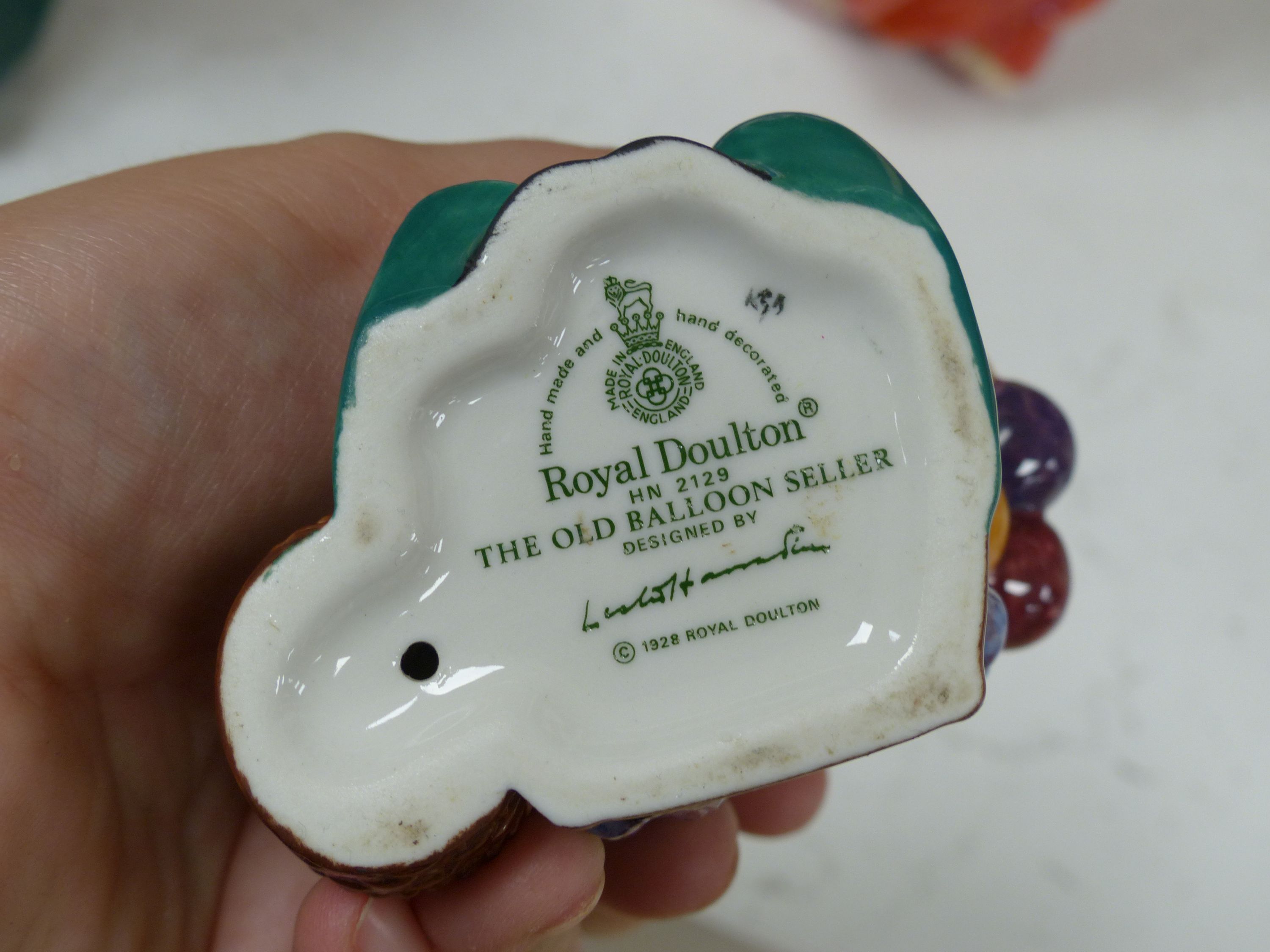 Ten Royal Doulton figurines, including 'Sara', 'The Judge', 'The Old Balloon Seller', 'Elaine' and others